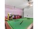 Fun game room equipped with a pool table, arcade games, and a playful atmosphere at 2567 Oneida Loop, Kissimmee, FL 34747
