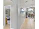 Hallway with gallery wall, leading to an open-concept living room and adjacent bedroom at 2567 Oneida Loop, Kissimmee, FL 34747