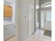 Hallway with laundry room and entryway featuring neutral paint and tiled floors at 2567 Oneida Loop, Kissimmee, FL 34747