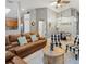 Open-concept living space featuring a leather sofa, tile floors, and views into the kitchen and dining area at 2567 Oneida Loop, Kissimmee, FL 34747