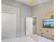 Main bedroom with stylish ceiling fan, a dresser with television, and a light pink blanket accent at 2567 Oneida Loop, Kissimmee, FL 34747