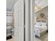 View from bathroom of main bedroom with stylish ceiling fan, a dresser with television, and white comforter at 2567 Oneida Loop, Kissimmee, FL 34747