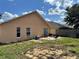 Backyard view with a small patio area, partial fence, and simple landscaping at 260 Piccolo Way, Davenport, FL 33896