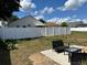 Backyard featuring a patio area and a white vinyl fence for added privacy at 260 Piccolo Way, Davenport, FL 33896