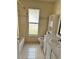 Bright bathroom showcasing a shower-tub, a large frosted glass window, and white fixtures at 260 Piccolo Way, Davenport, FL 33896