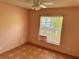 Cozy bedroom with tile flooring, a window, and ceiling fan at 260 Piccolo Way, Davenport, FL 33896
