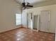 Spacious bedroom featuring tiled floor, ceiling fan, and a window with natural light at 260 Piccolo Way, Davenport, FL 33896