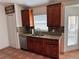 Kitchen showcasing wood cabinets, granite countertops, and stainless steel dishwasher at 260 Piccolo Way, Davenport, FL 33896