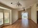 Bright living room with large windows, ceiling fan, and access to outdoor space at 260 Piccolo Way, Davenport, FL 33896