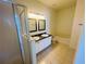 Bathroom featuring double sinks, a walk-in shower, and a soaking tub at 2728 Portchester Ct, Kissimmee, FL 34744