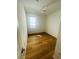 Compact bedroom featuring wood floors, a ceiling fan, and natural light from a window at 2728 Portchester Ct, Kissimmee, FL 34744