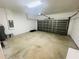 Spacious garage featuring an automatic door opener and concrete floor at 2728 Portchester Ct, Kissimmee, FL 34744