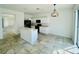 Bright kitchen featuring white cabinetry, modern black appliances, and an island with a breakfast bar at 2728 Portchester Ct, Kissimmee, FL 34744