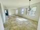 Bright living room featuring tile flooring and ample natural light from multiple windows at 2728 Portchester Ct, Kissimmee, FL 34744