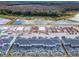 Wide aerial view of a community with newly built homes, private pools and a serene waterfront in the distance at 2970 Protagonist St, Kissimmee, FL 34746