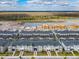 Expansive aerial view of the development's homes, featuring screened pools, and a picturesque natural landscape at 2970 Protagonist St, Kissimmee, FL 34746