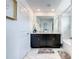 Bathroom featuring double sinks, dark cabinets, a shower-tub combo, and tile flooring at 2970 Protagonist St, Kissimmee, FL 34746