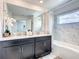 Bathroom with double sinks, dark cabinets, and a shower-tub combo at 2970 Protagonist St, Kissimmee, FL 34746