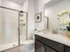 Bathroom with a glass-enclosed shower and a vanity with solid surface countertops at 2970 Protagonist St, Kissimmee, FL 34746