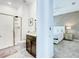 A bathroom features a glass shower, modern fixtures, and a glimpse into the bedroom at 2970 Protagonist St, Kissimmee, FL 34746