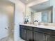Bathroom featuring double vanity, large mirror, and glass shower at 2970 Protagonist St, Kissimmee, FL 34746