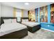 Bright bedroom featuring two beds, carpet floors, and a vibrant 'Minions' themed accent wall at 2970 Protagonist St, Kissimmee, FL 34746