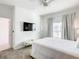 Bright bedroom with a ceiling fan, large window with curtains, and a wall-mounted TV for convenience at 2970 Protagonist St, Kissimmee, FL 34746