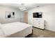 Clean bedroom featuring a modern TV, dresser, bed, and light fixture at 2970 Protagonist St, Kissimmee, FL 34746