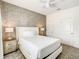 Stylish bedroom with a tufted headboard, accent wall, ceiling fan, and neutral tones for a relaxing atmosphere at 2970 Protagonist St, Kissimmee, FL 34746