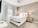 Elegant bedroom with a textured wall, ceiling fan, bedside lamps, and a cozy, inviting ambiance at 2970 Protagonist St, Kissimmee, FL 34746