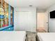 Bedroom with closet and 'Minions' themed accent wall, offering ample storage space and playful decor at 2970 Protagonist St, Kissimmee, FL 34746