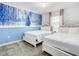 Charming bedroom with two queen beds and a 'Frozen' themed accent wall at 2970 Protagonist St, Kissimmee, FL 34746