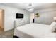 Clean bedroom featuring a modern TV, dresser, bed, and light fixture at 2970 Protagonist St, Kissimmee, FL 34746