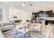 Wide angle view of dining area flows into a bright, modern kitchen and comfy living room at 2970 Protagonist St, Kissimmee, FL 34746