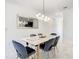 Bright dining room features a modern light fixture and marble table with seating for six at 2970 Protagonist St, Kissimmee, FL 34746