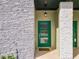 Up close, green front door with glass panels complements the modern design with stone details at 2970 Protagonist St, Kissimmee, FL 34746