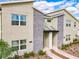 Modern townhome exterior with stone facade and contemporary design details in a well-maintained community at 2970 Protagonist St, Kissimmee, FL 34746