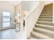 Bright foyer featuring marble floors, console table, stairway, and a glimpse of the bathroom at 2970 Protagonist St, Kissimmee, FL 34746