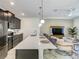 Modern kitchen featuring stainless steel appliances, a large island, and open layout with seating at 2970 Protagonist St, Kissimmee, FL 34746