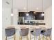 Modern kitchen features a white countertop island with pendant lighting and stainless steel appliances at 2970 Protagonist St, Kissimmee, FL 34746