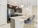 Bright kitchen featuring stainless steel appliances, black cabinets, and a spacious island with seating at 2970 Protagonist St, Kissimmee, FL 34746