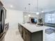 Open-concept kitchen with a large island, modern appliances, and seamless integration with the living area at 2970 Protagonist St, Kissimmee, FL 34746