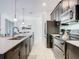 Well-equipped kitchen with modern stainless steel appliances, a spacious island, and elegant finishes at 2970 Protagonist St, Kissimmee, FL 34746