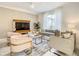 Inviting living room with stylish furniture, a modern TV, and an abundance of natural light at 2970 Protagonist St, Kissimmee, FL 34746