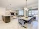 Open floor plan showing kitchen, dining, and living areas, with access to an outdoor patio at 2970 Protagonist St, Kissimmee, FL 34746