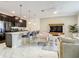Open concept living room with modern kitchen, stylish furniture, and sleek marble floors at 2970 Protagonist St, Kissimmee, FL 34746