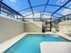 A private screened-in pool area with a spa is surrounded by neutral colored walls and has a view of the sky at 2970 Protagonist St, Kissimmee, FL 34746