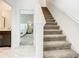Carpeted staircase leading to the upper level, with views of the bedroom and bathroom, enhancing the home's appeal at 2970 Protagonist St, Kissimmee, FL 34746