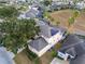 Stunning aerial view of a home with a screened-in pool, solar panels, and mature landscaping at 303 Plumoso Loop, Davenport, FL 33897