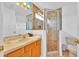 Bathroom featuring a glass-enclosed shower, spacious vanity with a sink, and modern fixtures at 303 Plumoso Loop, Davenport, FL 33897